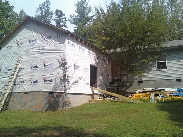Tyvek wrapped gable on a new room addition beside an existing home in Elliston